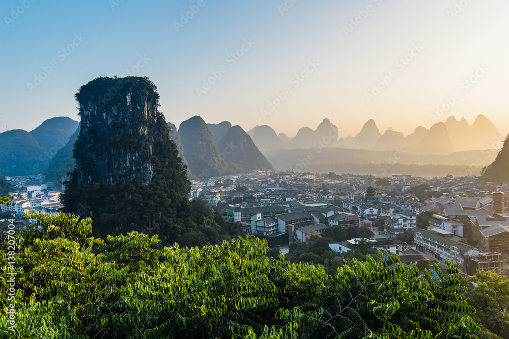 Yangshuo sunset cityscape skyline with Karst mountains in Guangxi Province, China
