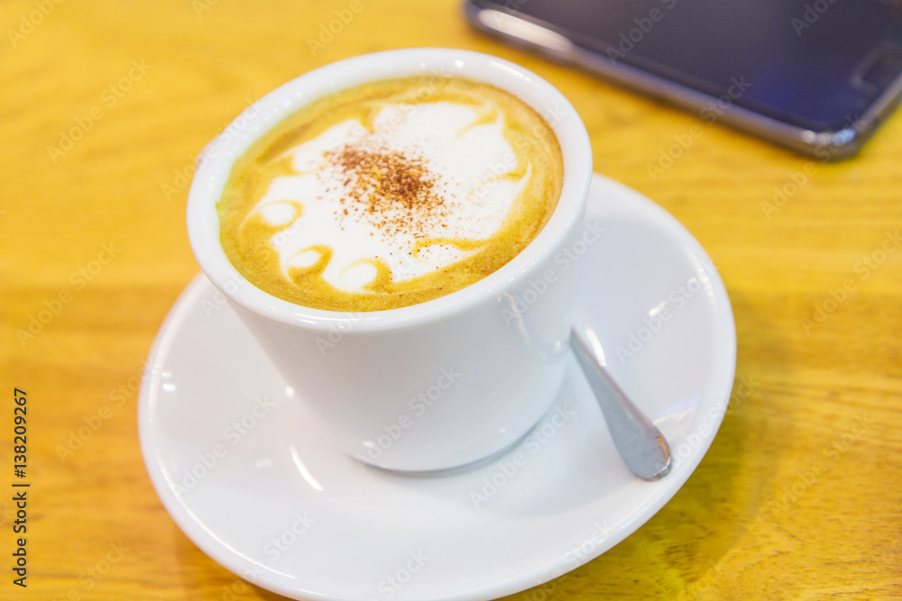 hot coffee on the table and smartphone on background hot coffee on the table and smartphone on background