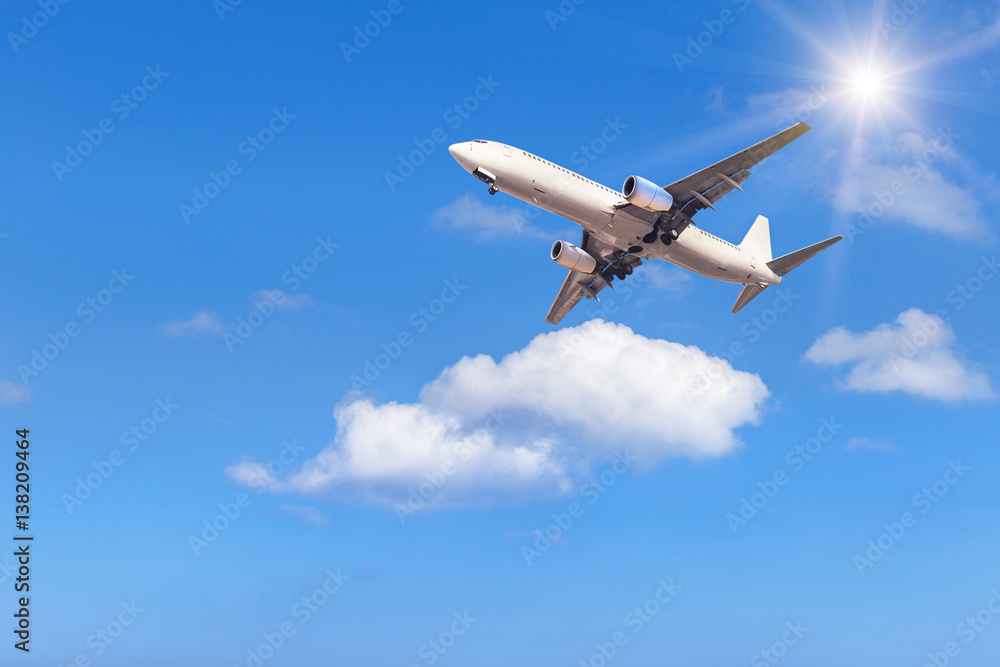 airplane flying away in to sky with white clouds on sunlight airplane flying away in to sky with white clouds on sunlight
