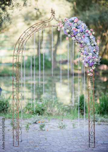 Elegant steel wedding altar decorated with crystal chains and blue flower garland
