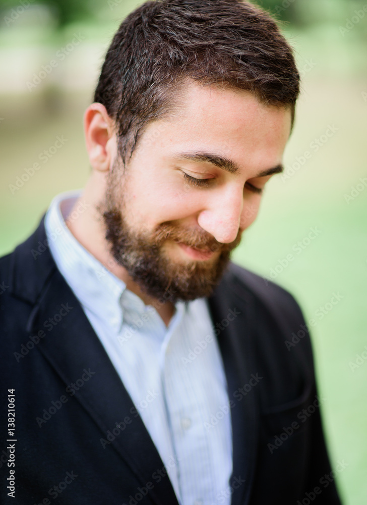 Bearded man with light charming smile on his face Bearded man with light charming smile on his face