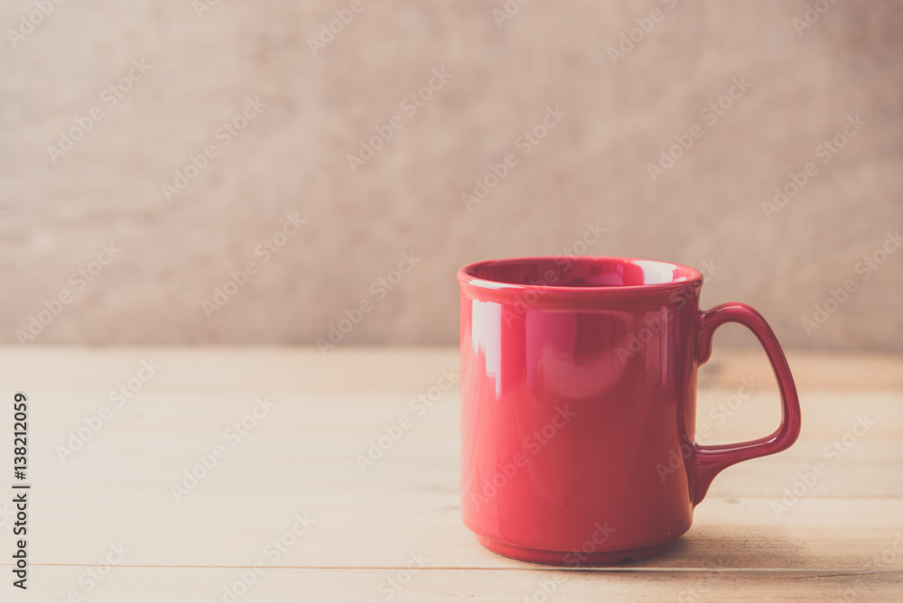 Fototapeta premium red cup on wooden wall background