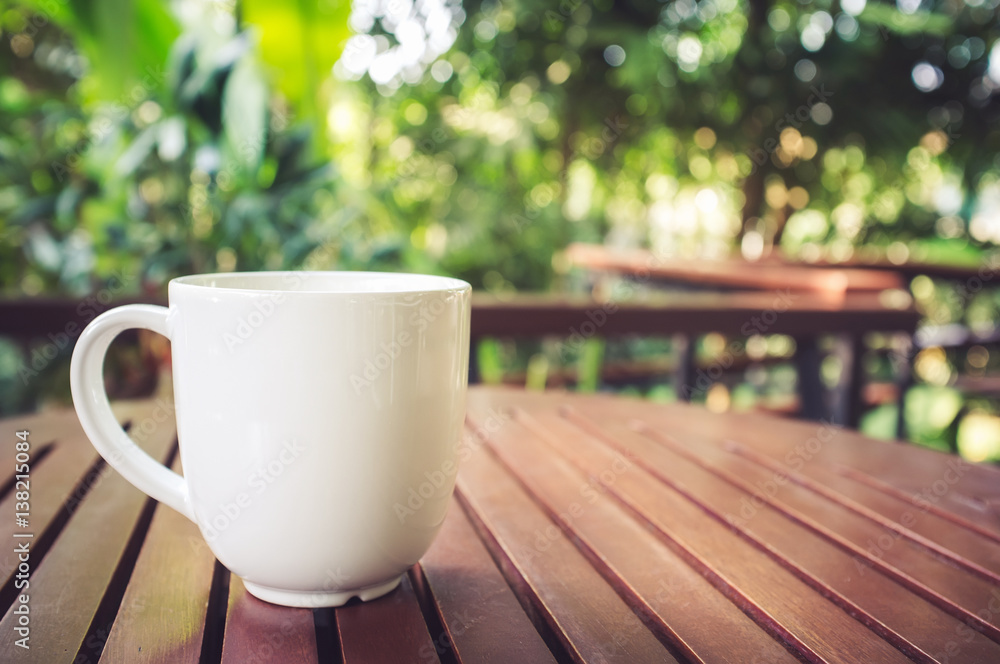 Cup of coffee on wooden table in coffee shop. Cup of coffee on wooden table in coffee shop.