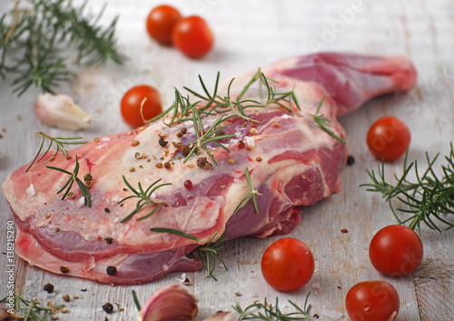 Fresh and raw meat. Leg of lamb on wood background