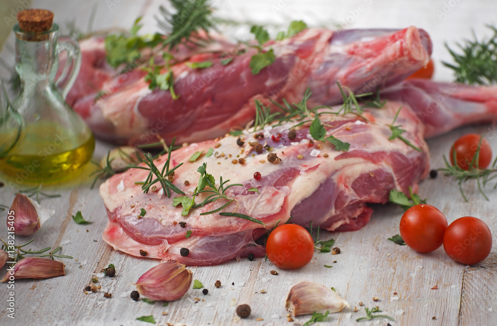 Fresh and raw meat. Leg of lamb on wood background Fresh and raw meat. Leg of lamb on wood background