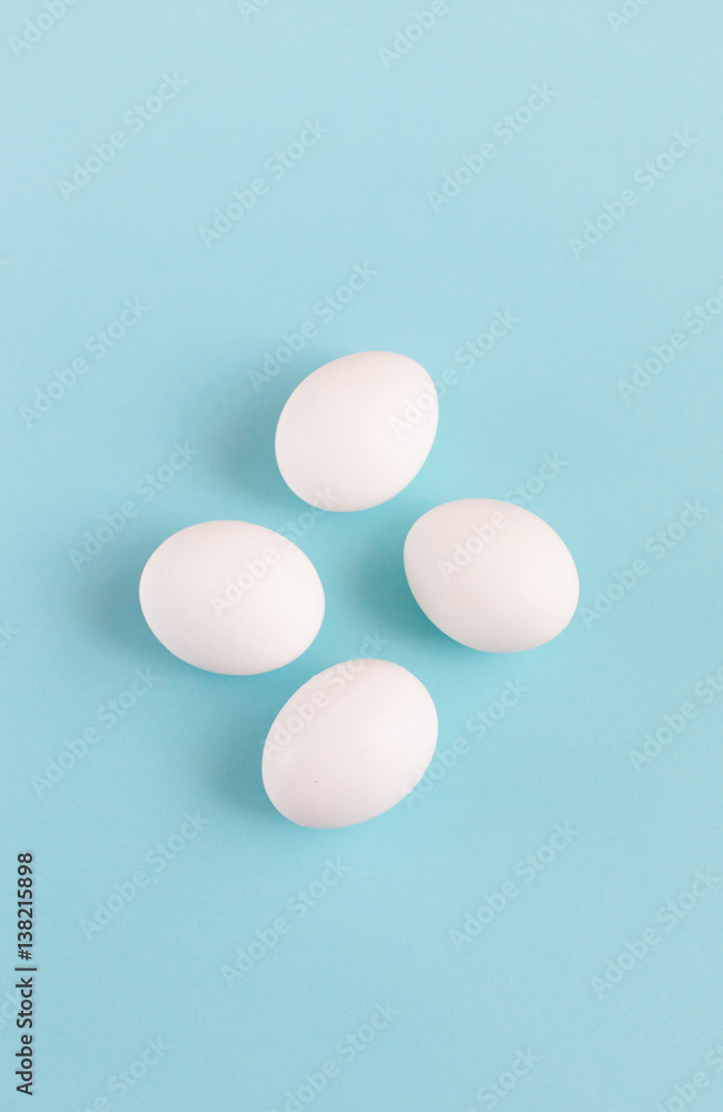 Easter decoration white eggs on a light blue background, minimal design with space for text, vertical image