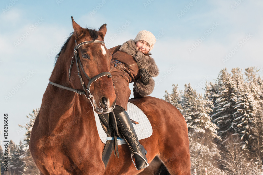 Obraz premium Woman in brown dress and brown horse in a winter