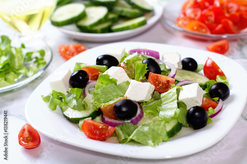 Fresh greek salad on white table