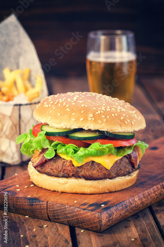 American Burger with bacon,cheese,tomato,lettuce,french fries and beer