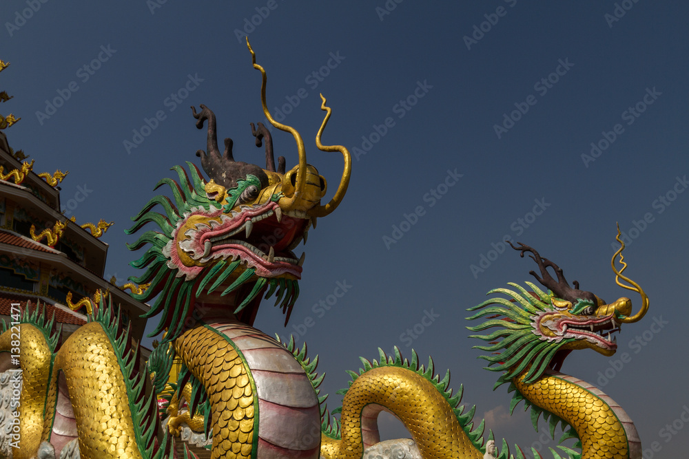 Fototapeta premium Amazing golden dragon head at chinese temple with blue sky background