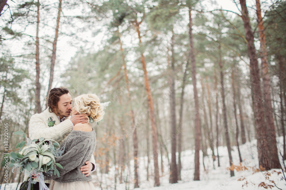 Beautiful romantic couple kissing in the winter park Beautiful romantic couple kissing in the winter park