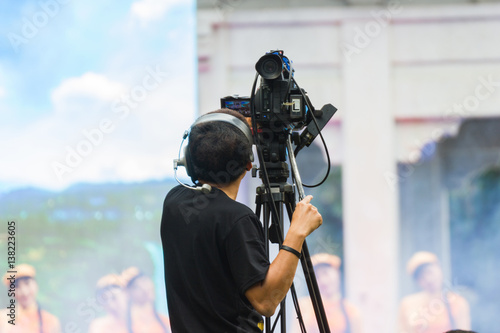 Blur - professional cameraman - covering on event with a video 
