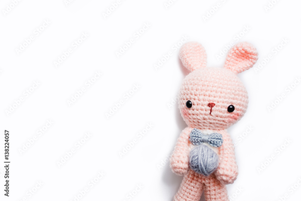 Rabbit crochet doll with yarn ball on white background Rabbit crochet doll with yarn ball on white background