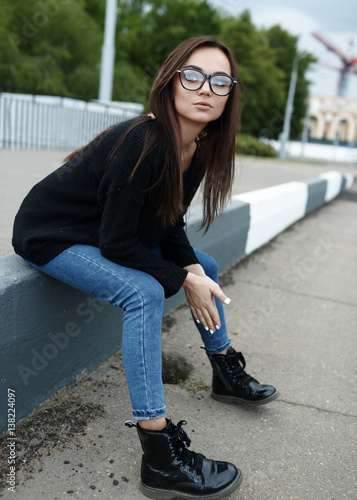 Young girl in glasses walking in summer in the city. The concept of lifestyle and fashion © khmelev