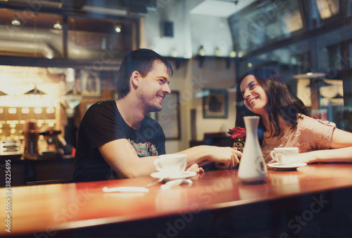 young guy and girl talk in a cafe © myronovychoksana