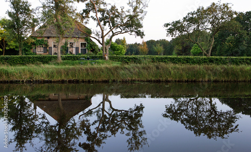 Farmhouse in the Netherlands. Wold Aa canal. Ruinerwold Drente. Buitenhuizerweg. Reflections in the water. photo