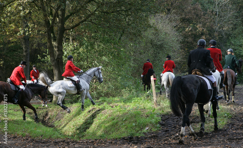 Foxhunt. The fox hunt. Horses. Horseriding at the countrysite.  Horses jumping over a ditch. Havelte Drenthe Netherlands. photo