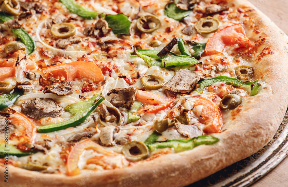 Rustic pizza with salami, mozzarella, olives and basil top view with copy space Rustic pizza with salami, mozzarella, olives and basil top view with copy space