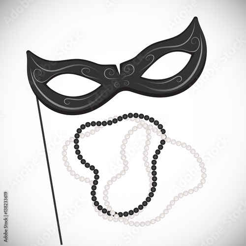 Carnival mask on a stick. Black and white pearl necklace. Mardi Gras