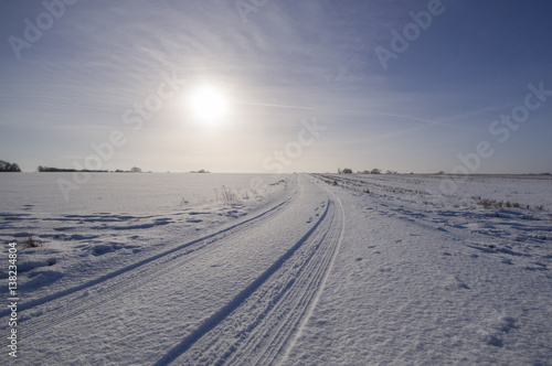 Direct sunlight and fresh snowfall on a field in Suffolk  UK