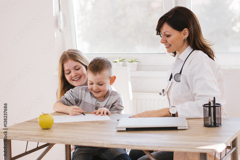 Female doctor in office with kids. Female doctor in office with kids.