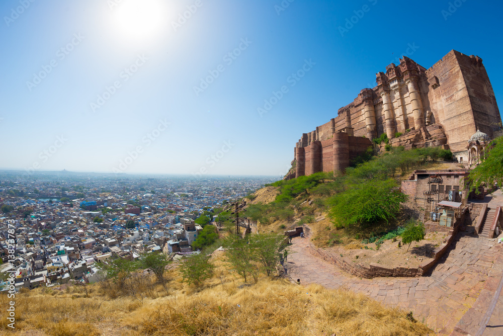 Cityscape at Jodhpur at dusk. The majestic fort perched on top dominating the blue town. Scenic travel destination and famous tourist attraction in Rajasthan, India.