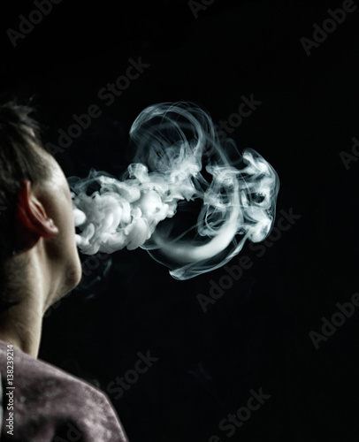 Vape trick jellyfish in performance of vaper on dark background