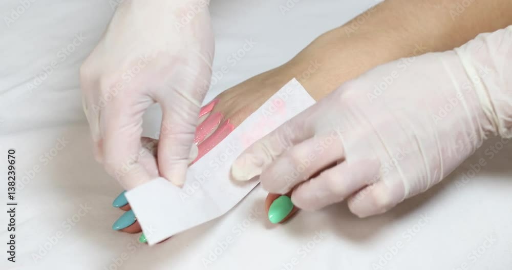Process depilation female legs and hands in a beauty salon Process depilation female legs and hands in a beauty salon