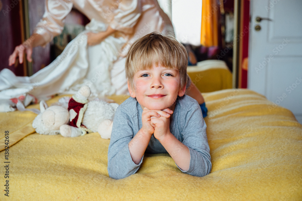 Fototapeta premium Cute handsome boy (5 years) lying on the bed.
