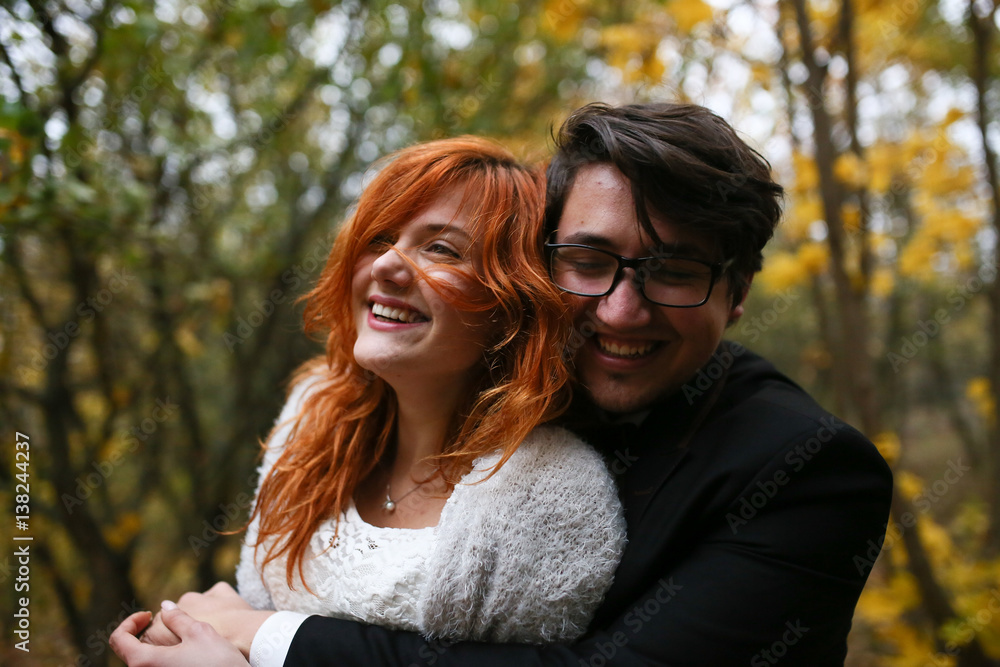 The charming brides embracing in the park