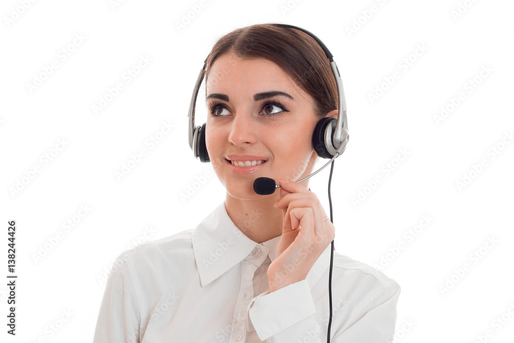 cheerful brunette woman working in call center with headphones and microphone and smiling aside isolated on white background cheerful brunette woman working in call center with headphones and microphone and smiling aside isolated on white background