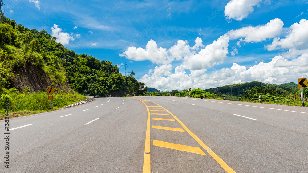 Winding Paved Road with blue sky in the mountain.