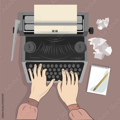 Writer typing with retro writing machine. View from above.