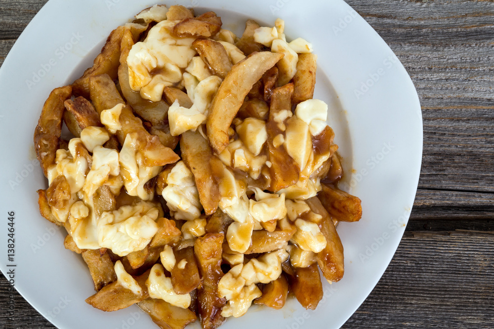 Poutine quebec meal with french fries, gravy and cheese curds Poutine quebec meal with french fries, gravy and cheese curds