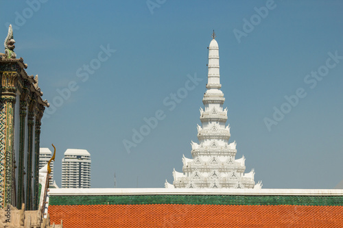 White stupa and tiered roof structure at the Temple of the Emerald Buddha (Wat Phra Kaew), Grand Palace complex, Bangkok, Thailand