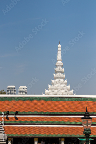 White stupa and tiered roof structure at the Temple of the Emerald Buddha (Wat Phra Kaew), Grand Palace complex, Bangkok, Thailand