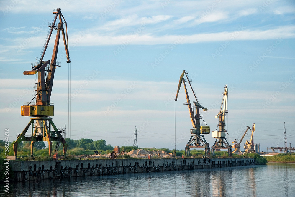 Port cranes in the cargo river port of Vologda.