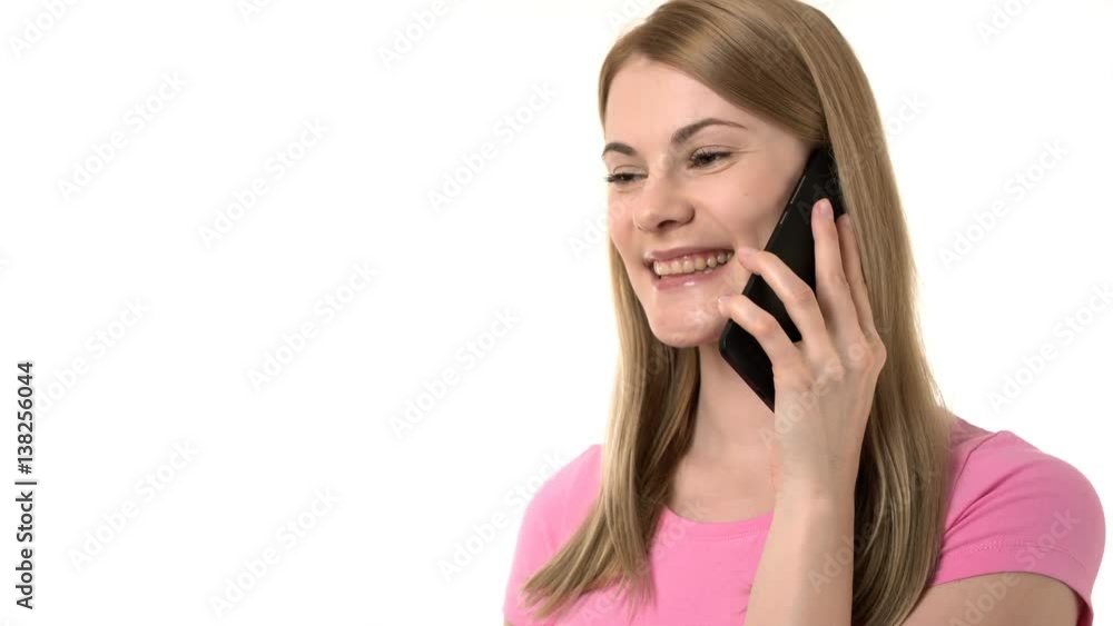 Beautiful businesswoman in pink t-shirt talking on the phone with friends. Isolated white background Beautiful businesswoman in pink t-shirt talking on the phone with friends. Isolated white background