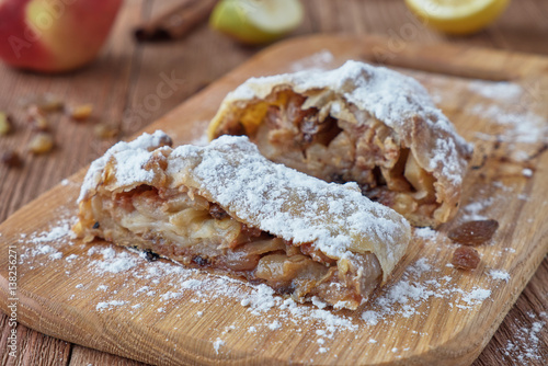 Fresh baked homemade apple strudel with powdered sugar photo