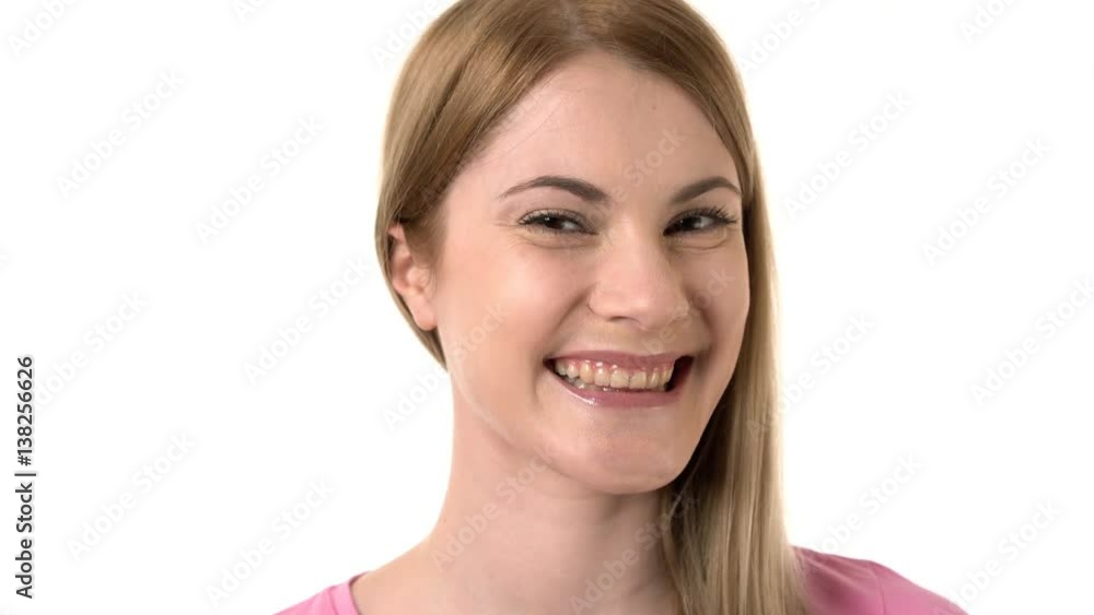 Beautiful attractive young woman smiling into camera. Isolated white background. Winking at camera. Beautiful attractive young woman smiling into camera. Isolated white background. Winking at camera.