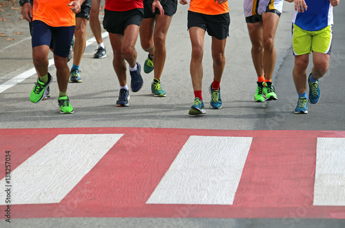 many marathon athletes run fast over the pedestrian crossing in