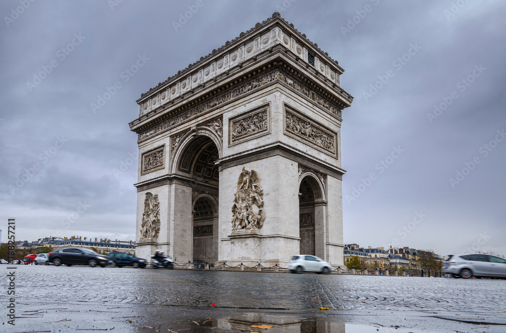 Triumphal arch. Arc de triomphe. View of Place Charles de Gaulle. Famous touristic architecture landmark in rainy day. Long exposure photography. Paris. France. Triumphal arch. Arc de triomphe. View of Place Charles de Gaulle. Famous touristic architecture landmark in rainy day. Long exposure photography. Paris. France.