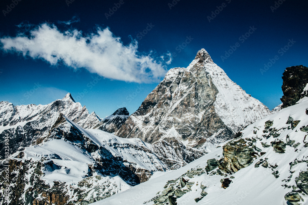 Matterhorn and winter mountain range with snow & blue sky in Switzerland