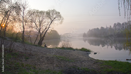 Man catch the fish at foggy sunrise