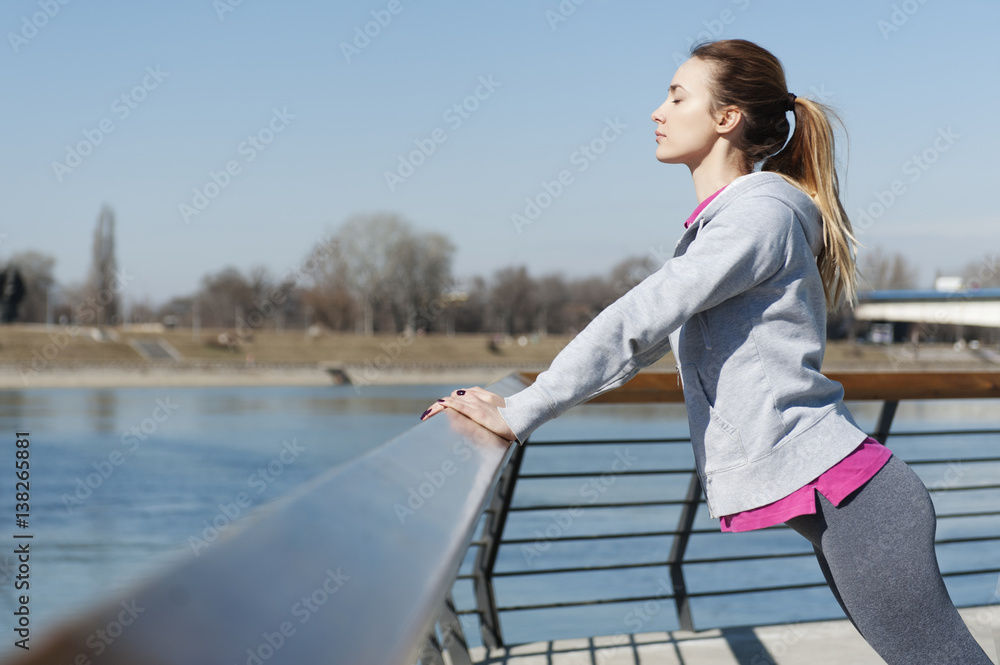 Young woman stretching after running