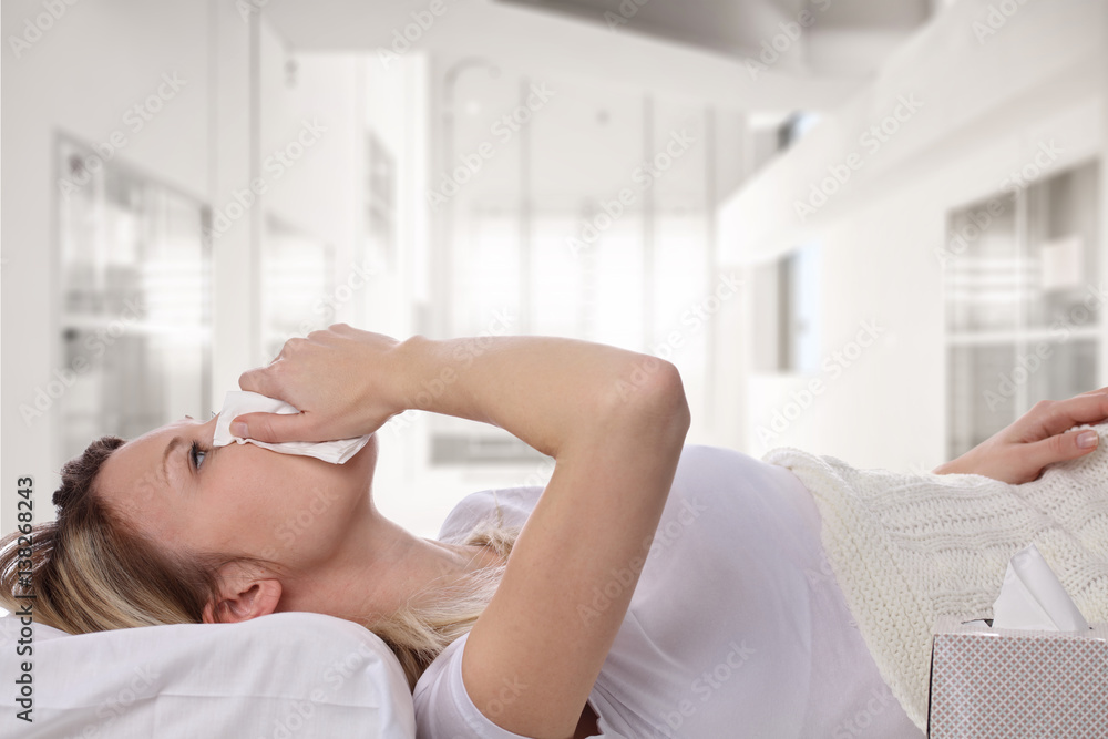 Woman sneezing and holding tissue ,flu symptoms. Healthcare and medical concept Woman sneezing and holding tissue ,flu symptoms. Healthcare and medical concept
