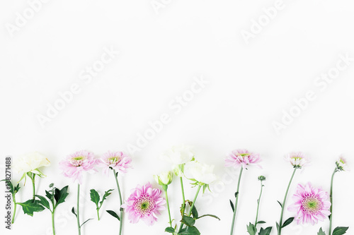 Floral pattern with roses and pink flowers, green leaves and branches on white background. Flat lay, top view. Floral background