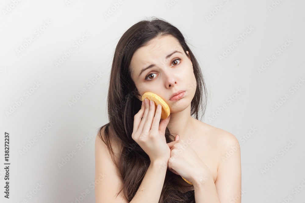 sad brunette wiping her face with a sponge sad brunette wiping her face with a sponge
