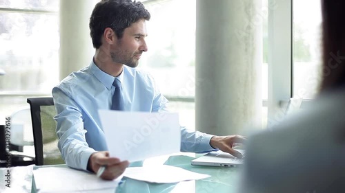 Businessman advising client in office