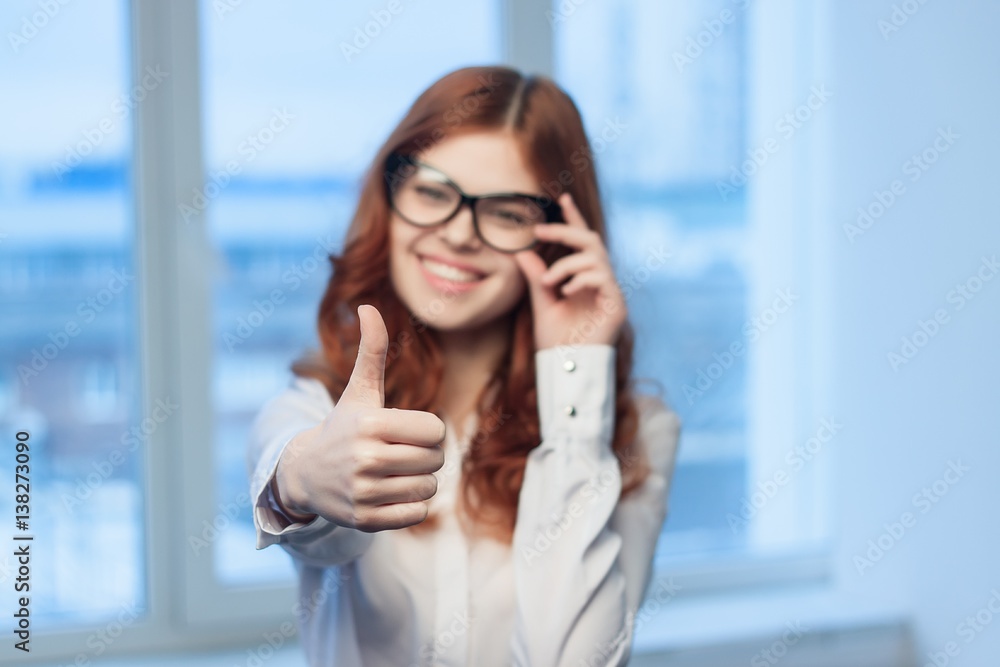 happy woman with glasses shows thumb of hand happy woman with glasses shows thumb of hand